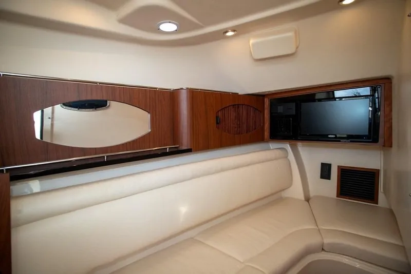 Slide: The Image of 2024 Grady-White Freedom 335 cabin interior with TV and comfortable seating. - 50