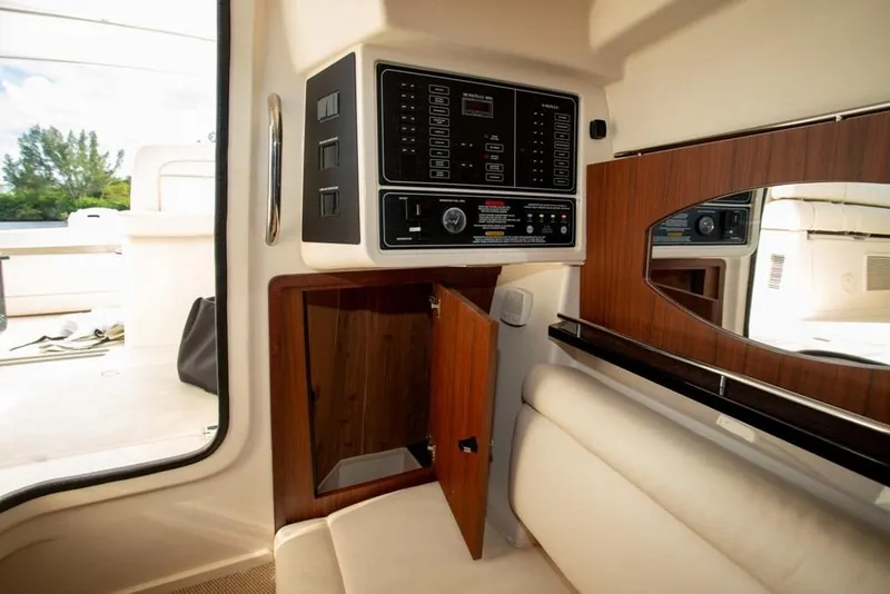 Slide: The Image of 2024 Grady-White Freedom 335 interior with control panel and wooden cabinetry. - 51