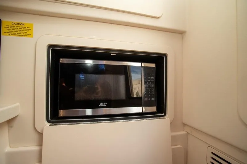 Slide: The Image of Microwave in 2024 Grady-White Freedom 335 boat interior, sleek and modern design. - 56