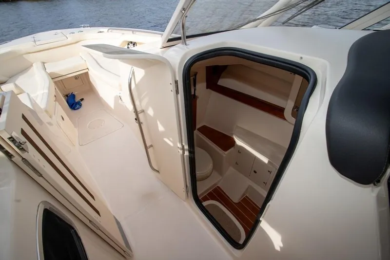 Slide: The Image of 2024 Grady-White Freedom 335 boat interior with open cabin door and seating area. - 57