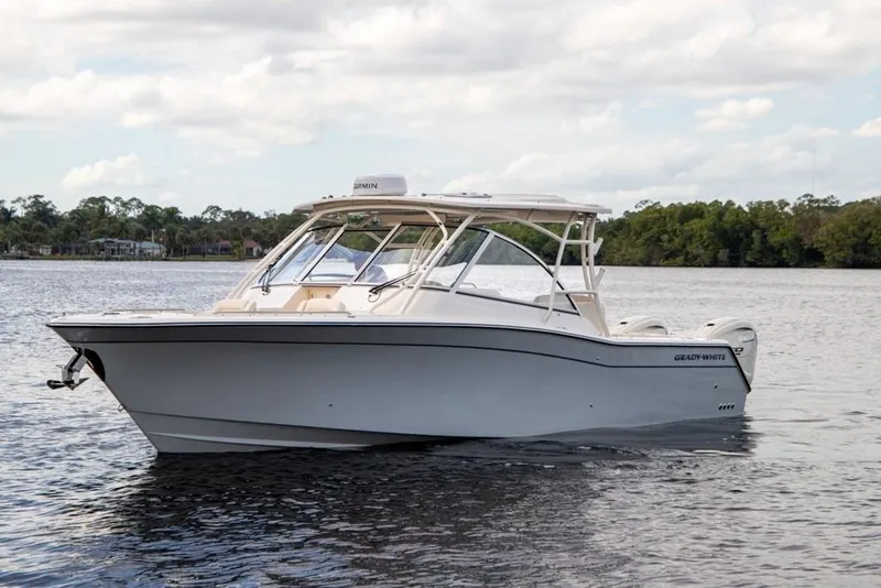 Slide: The Image of 2024 Grady-White Freedom 335 boat on calm water, side view. - 6