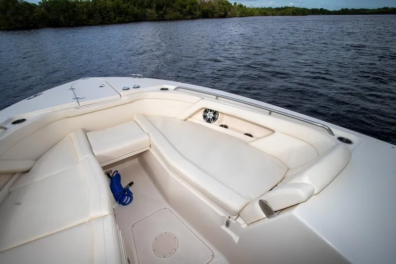 Slide: The Image of 2024 Grady-White Freedom 335 boat interior with white seating on calm water. - 60