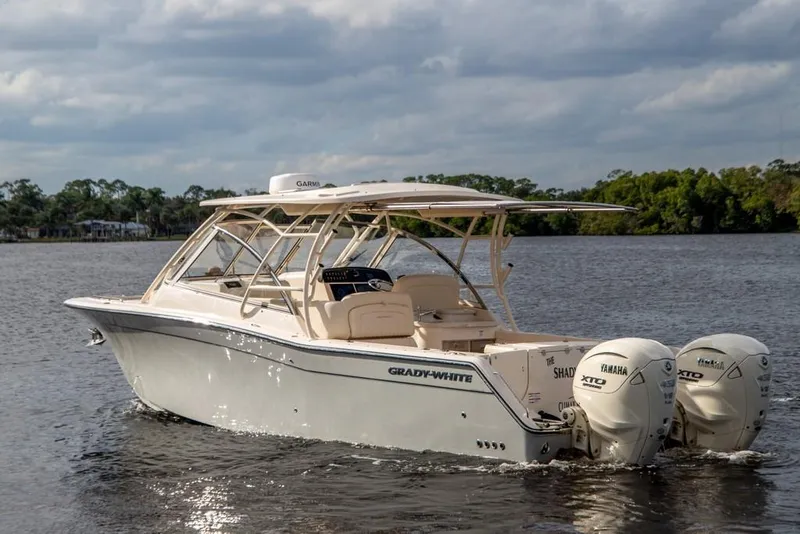 Slide: The Image of 2024 Grady-White Freedom 335 boat on water with Yamaha engines, under cloudy sky. - 69