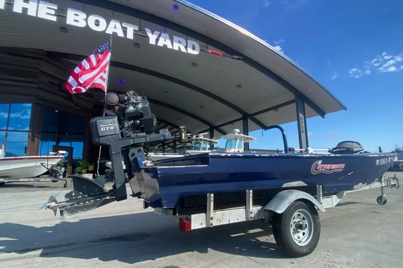 Slide: The Image of 2014 Cottonmouth 18x60 boat on trailer at The Boat Yard with American flag. - 11