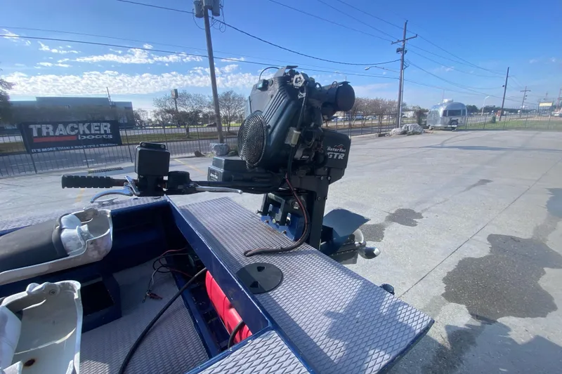 Slide: The Image of 2014 Cottonmouth 18x60 boat with motor, parked outdoors on a sunny day. - 6