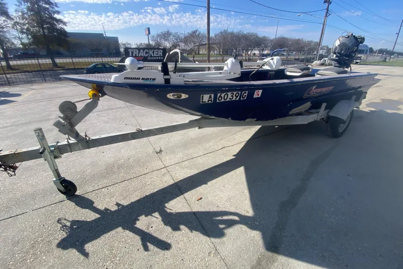 Slide: The Image of 2014 Cottonmouth 18x60 boat on trailer, parked outdoors under clear sky. - 8