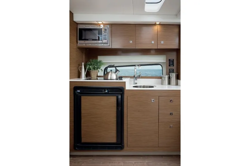 Slide: The Image of 2021 Cruisers Yachts 390 Express Coupe on serene lake with red umbrellas. - 11