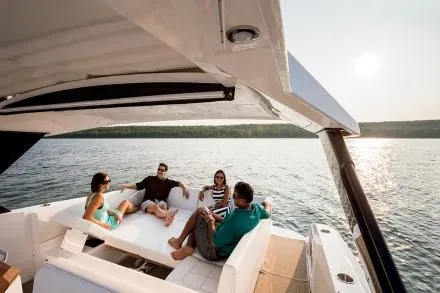 Slide: The Image of 2021 Cruisers Yachts 390 Express Coupe on serene lake with clear blue sky. - 3