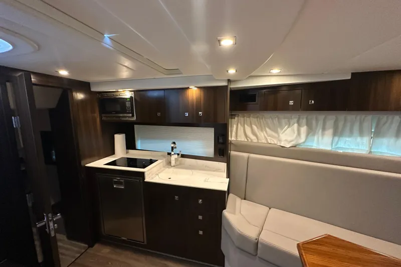 Slide: The Image of 2021 Cruisers Yachts 390 Express Coupe helm with white seating and control panel. - 33