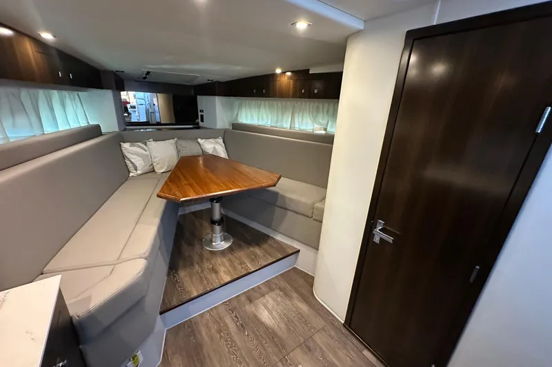 Slide: The Image of 2021 Cruisers Yachts 390 Express Coupe interior with white seating and red cushions. - 34