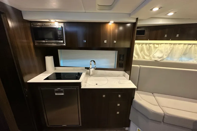 Slide: The Image of 2021 Cruisers Yachts 390 Express Coupe interior with seating, TV, and helm. - 38
