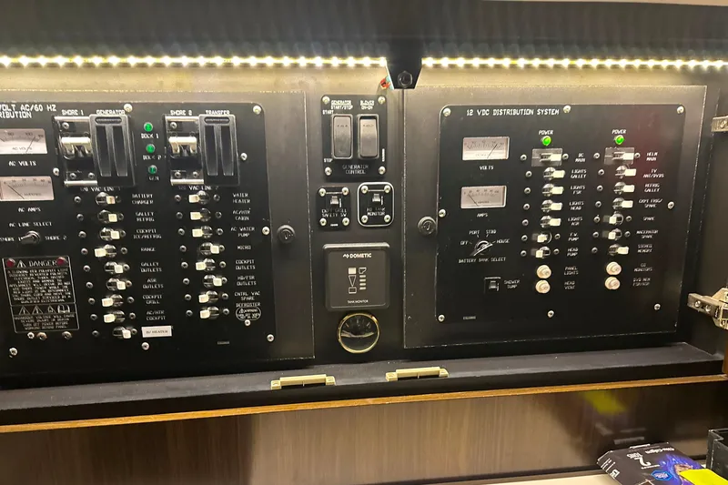 Slide: The Image of Electrical control panel of 2021 Cruisers Yachts 390 Express Coupe, illuminated with LED lights. - 64