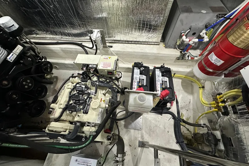 Slide: The Image of Engine room of 2021 Cruisers Yachts 390 Express Coupe with batteries and fire extinguisher. - 66
