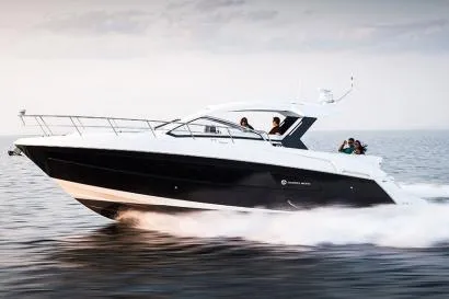 The Image of 2021 Cruisers Yachts 390 Express Coupe docked, featuring covered seating area. - 0