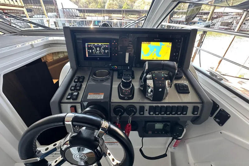 Slide: The Image of 2021 Cruisers Yachts 390 Express Coupe helm with navigation and control systems. - 15