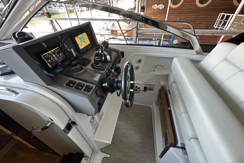 Slide: The Image of 2021 Cruisers Yachts 390 Express Coupe helm with modern navigation displays and controls. - 17