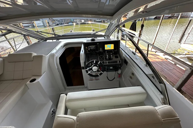Slide: The Image of 2021 Cruisers Yachts 390 Express Coupe helm with modern navigation system and comfortable seating. - 25