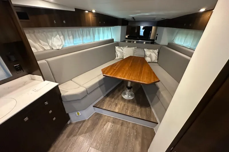Slide: The Image of Luxurious interior of 2021 Cruisers Yachts 390 Express Coupe with elegant seating and wooden table. - 30