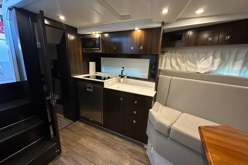 Slide: The Image of Luxurious interior of 2021 Cruisers Yachts 390 Express Coupe with modern kitchen amenities. - 32