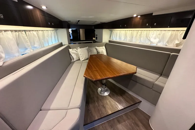 Slide: The Image of Luxurious interior of 2021 Cruisers Yachts 390 Express Coupe with elegant seating and wooden table. - 35