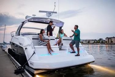 Slide: The Image of 2021 Cruisers Yachts 390 Express Coupe docked at marina, side view. - 4