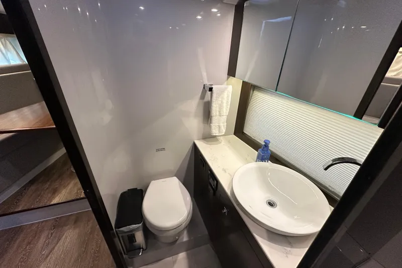 Slide: The Image of 2021 Cruisers Yachts 390 Express Coupe bathroom with modern sink and toilet. - 42
