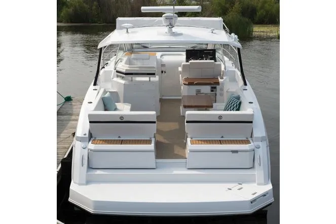 Slide: The Image of 2021 Cruisers Yachts 390 Express Coupe docked at marina, side view. - 5