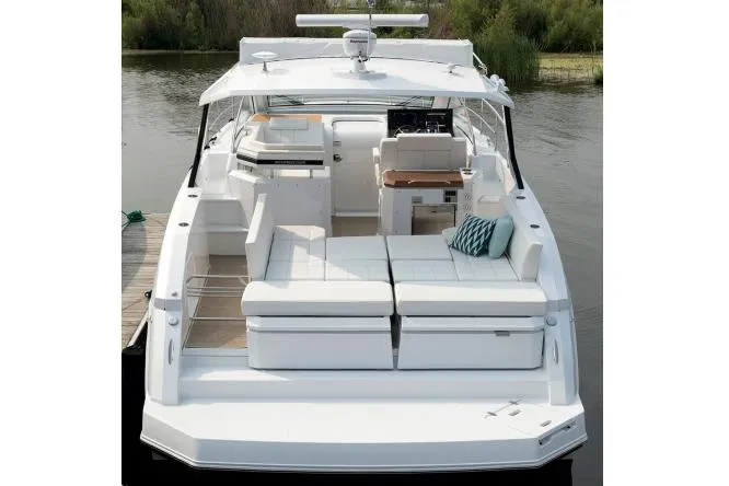 Slide: The Image of 2021 Cruisers Yachts 390 Express Coupe docked in marina, side view. - 7