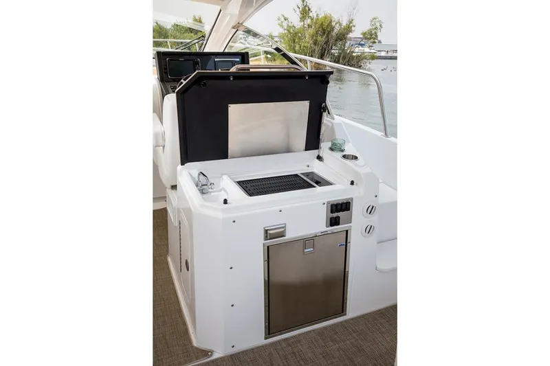 Slide: The Image of 2021 Cruisers Yachts 390 Express Coupe docked, featuring spacious deck and seating area. - 9