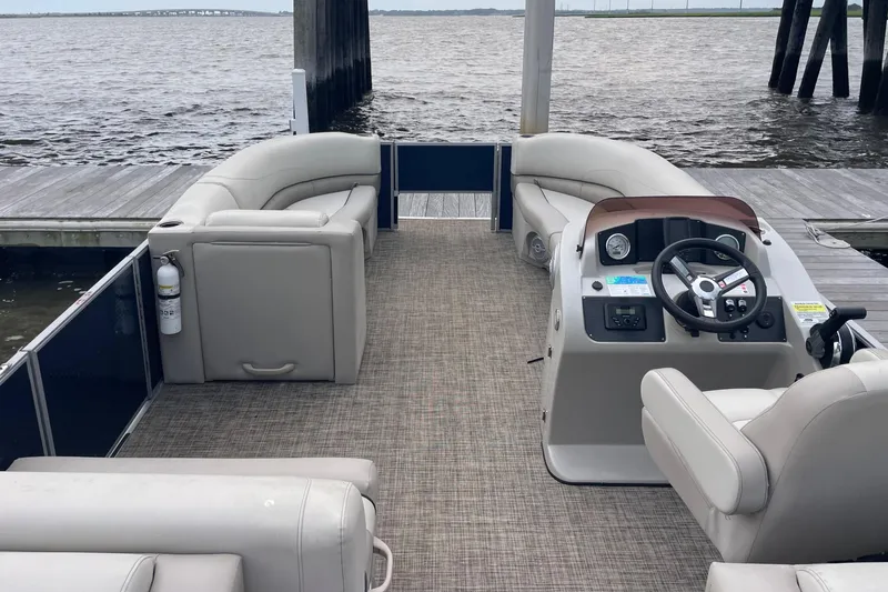 Slide: The Image of 2023 Cypress Cay Seabreeze 232 pontoon boat interior with helm and seating. - 3