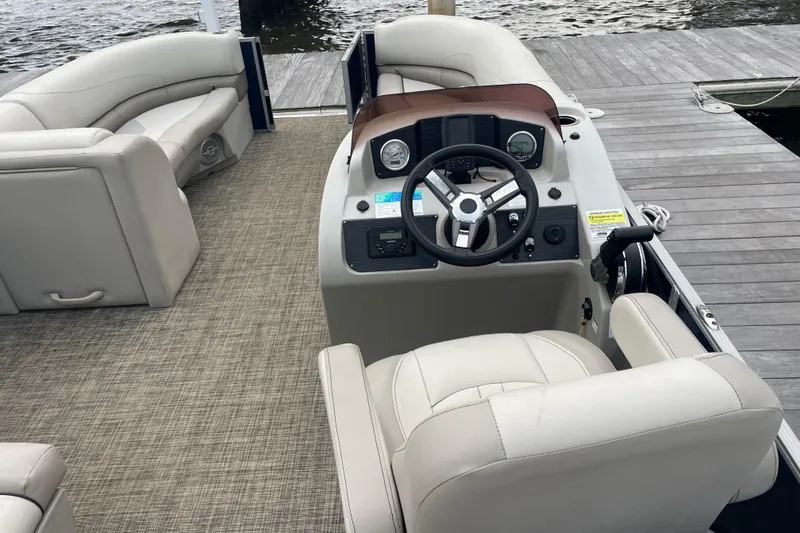 Slide: The Image of 2023 Cypress Cay Seabreeze 232 pontoon boat interior with helm and seating. - 4