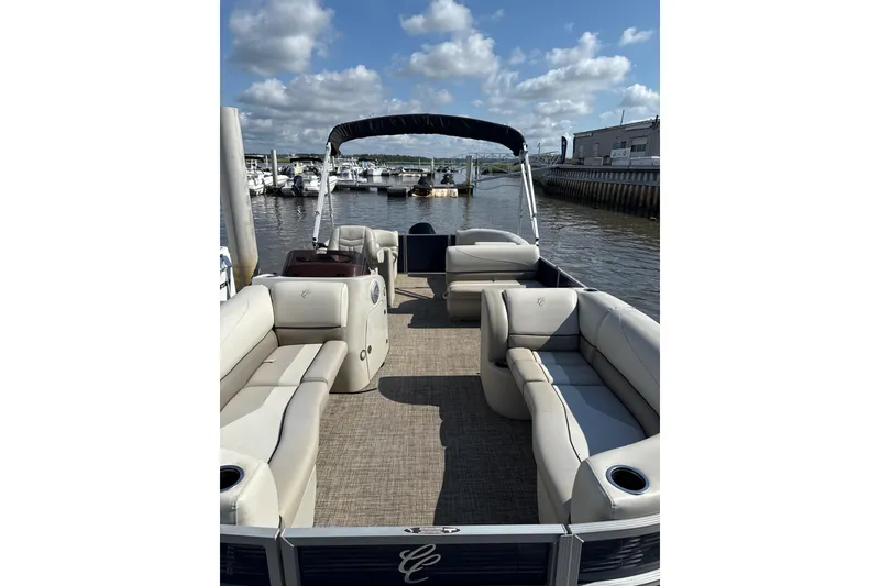 Slide: The Image of 2023 Cypress Cay Seabreeze 232 pontoon boat with spacious seating, docked at a marina. - 5