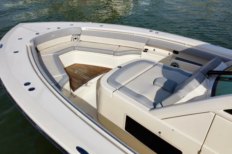 Slide: The Image of 2024 Scout 425 LXF boat interior with luxurious seating and teak flooring. - 10