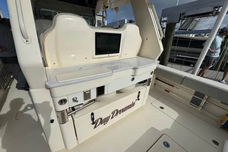 Slide: The Image of 2024 Scout 425 LXF boat interior with "Day Dreamin" text, featuring a control panel and storage. - 17