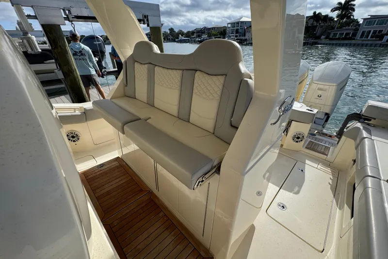 Slide: The Image of 2024 Scout 425 LXF boat interior with luxurious seating and wooden flooring. - 21