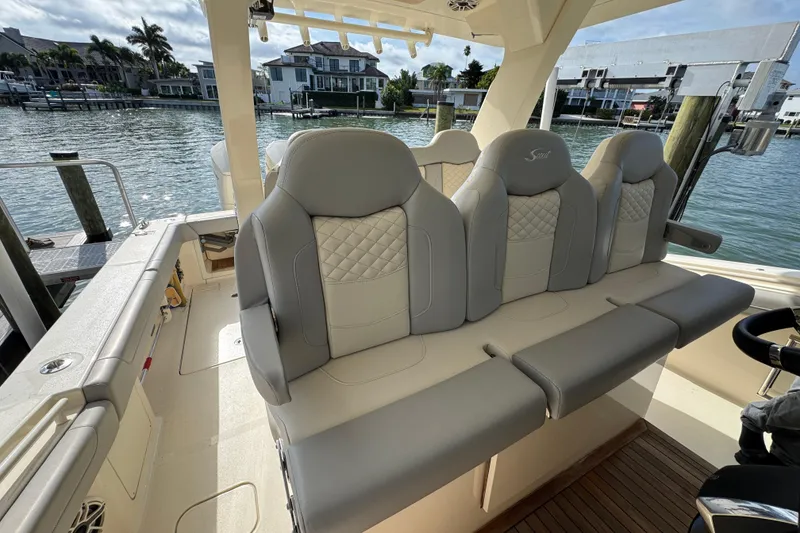 Slide: The Image of 2024 Scout 425 LXF boat interior with luxurious seating and waterfront view. - 25