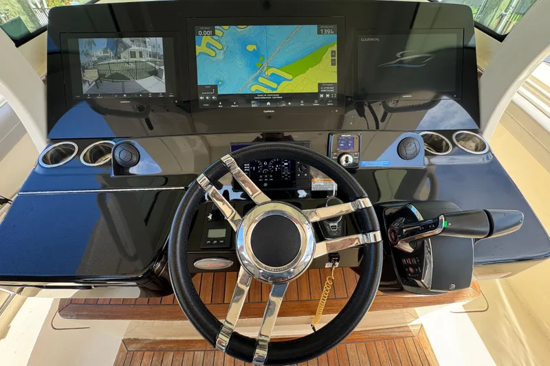 Slide: The Image of 2024 Scout 425 LXF helm with advanced navigation displays and controls. - 29