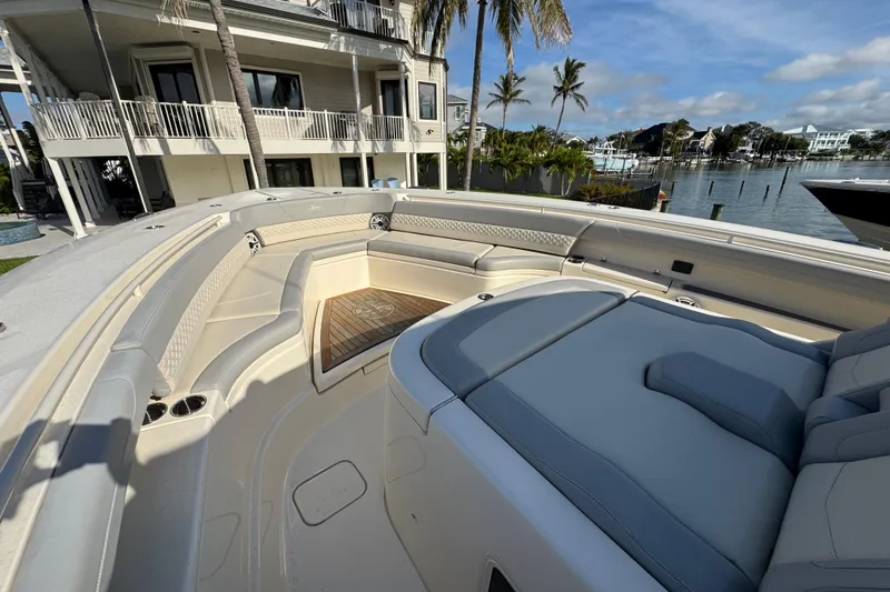 Slide: The Image of Luxurious 2024 Scout 425 LXF boat interior with plush seating and waterfront view. - 33