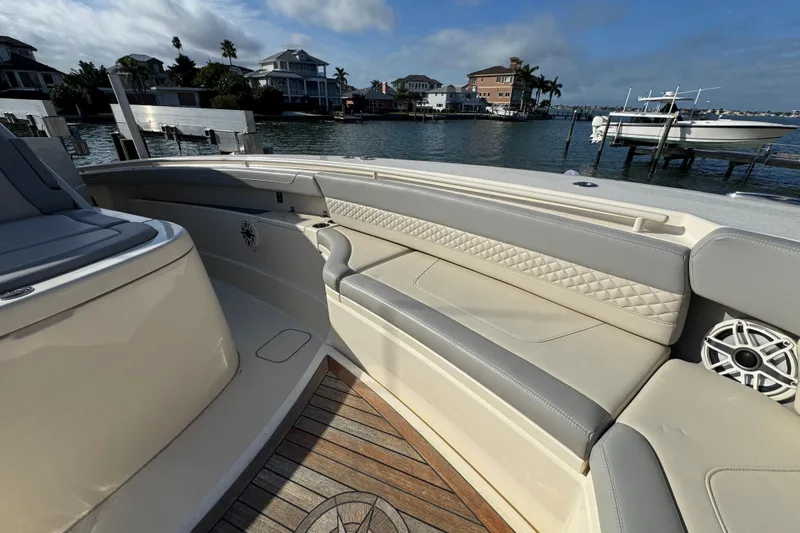 Slide: The Image of 2024 Scout 425 LXF boat interior with luxurious seating and waterfront view. - 34