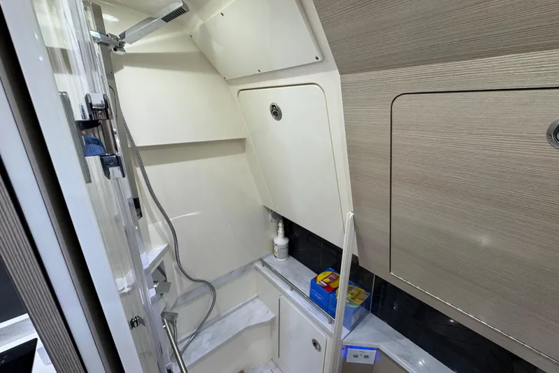 Slide: The Image of 2024 Scout 425 LXF interior bathroom with modern fixtures and storage compartments. - 48