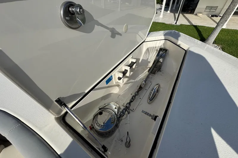 Slide: The Image of Open anchor compartment on 2024 Scout 425 LXF boat, showcasing anchor chain and mechanism. - 51