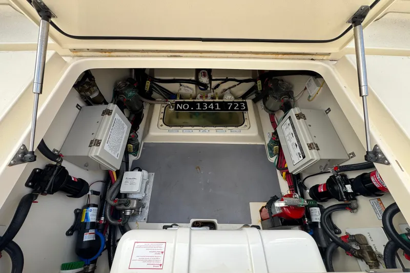 Slide: The Image of 2024 Scout 425 LXF engine compartment with wiring and components visible. - 52