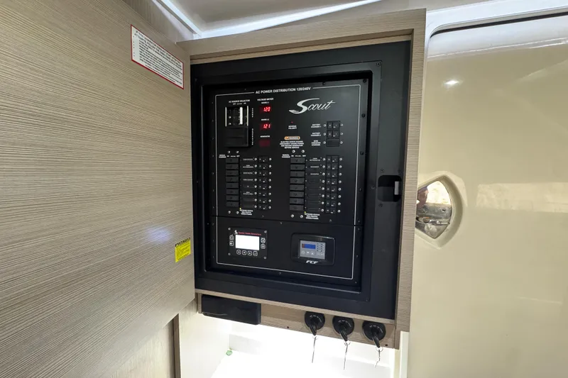 Slide: The Image of 2024 Scout 425 LXF electrical panel with controls and voltage meters. - 57