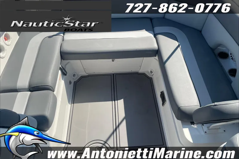 Slide: The Image of 2023 NauticStar 243 DC boat interior with gray seating, showcased by Antonietti Marine. - 10