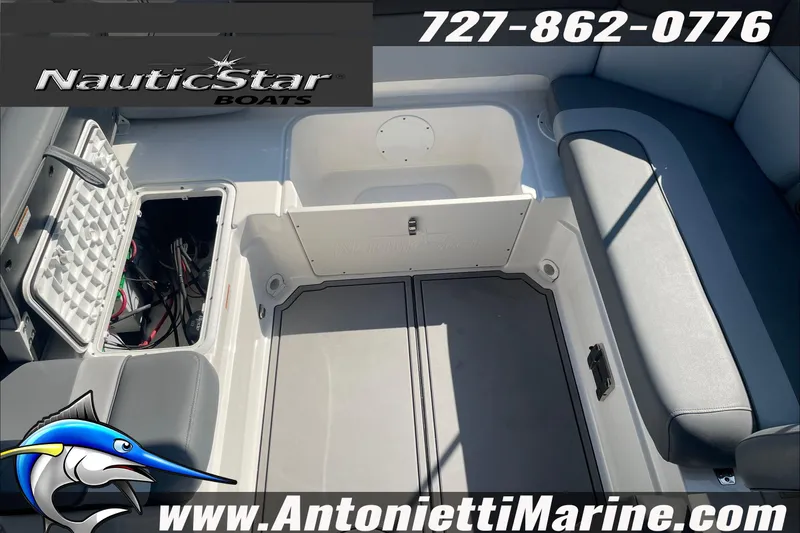 Slide: The Image of 2023 NauticStar 243 DC boat interior with storage compartments and seating. - 11