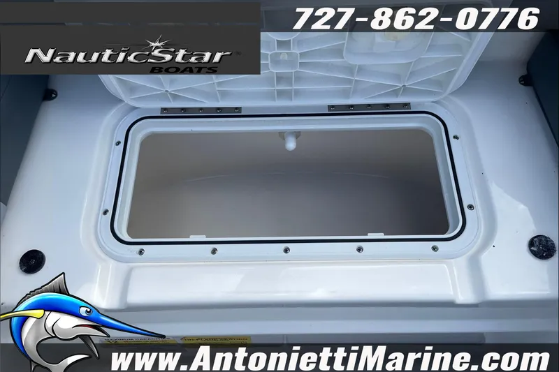 Slide: The Image of 2023 NauticStar 243 DC boat storage compartment with logo and contact details. - 18
