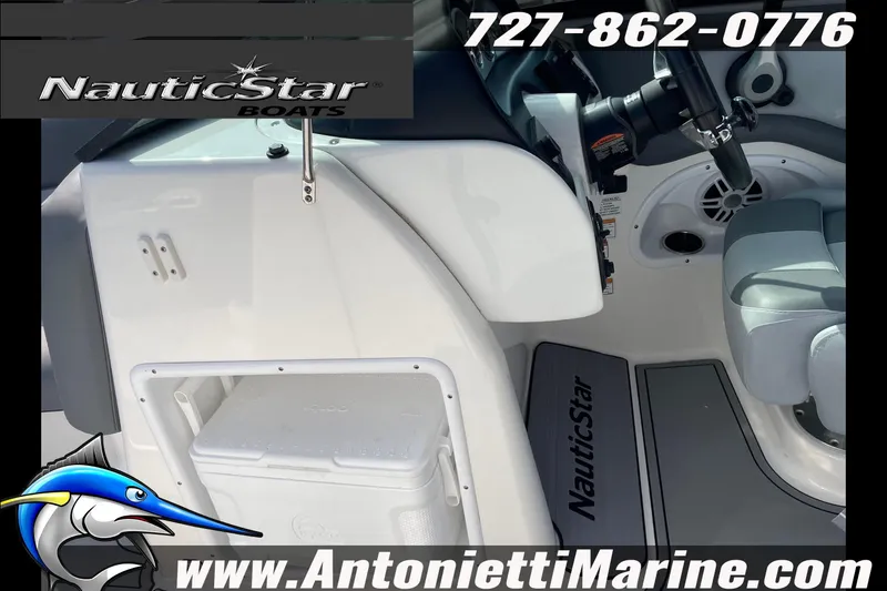 Slide: The Image of 2023 NauticStar 243 DC boat interior with steering wheel and storage compartment. - 19
