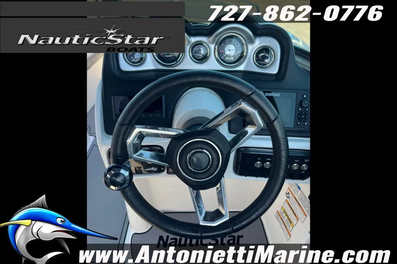 Slide: The Image of Steering wheel of 2023 NauticStar 243 DC boat, featuring dashboard controls and gauges. - 4