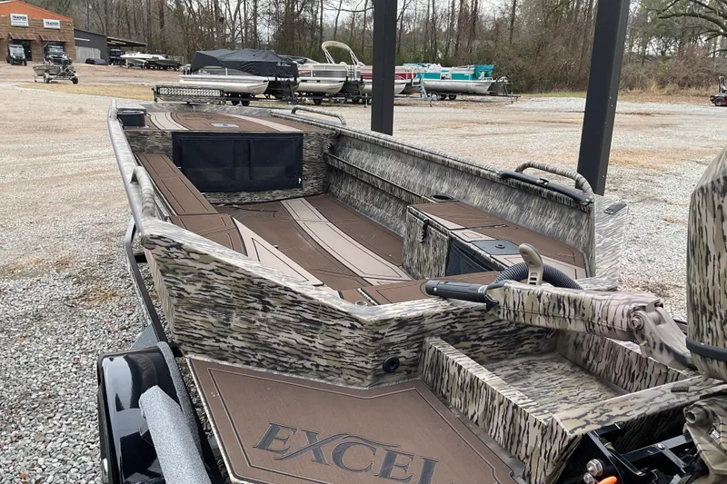 Slide: The Image of 2026 Excel Boats 1751 VIPER F4, camo design, parked outdoors, showcasing interior layout. - 4