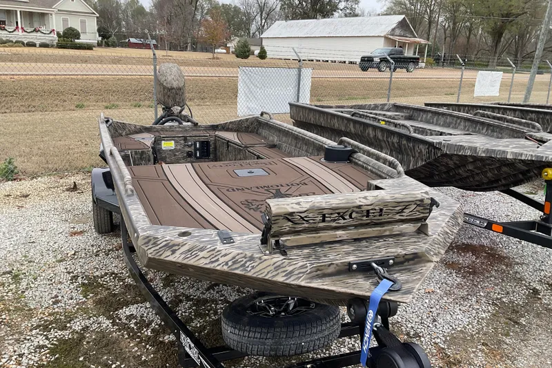 Slide: The Image of 2026 Excel Boats 1751 VIPER F4 in camouflage design, parked on a trailer. - 6